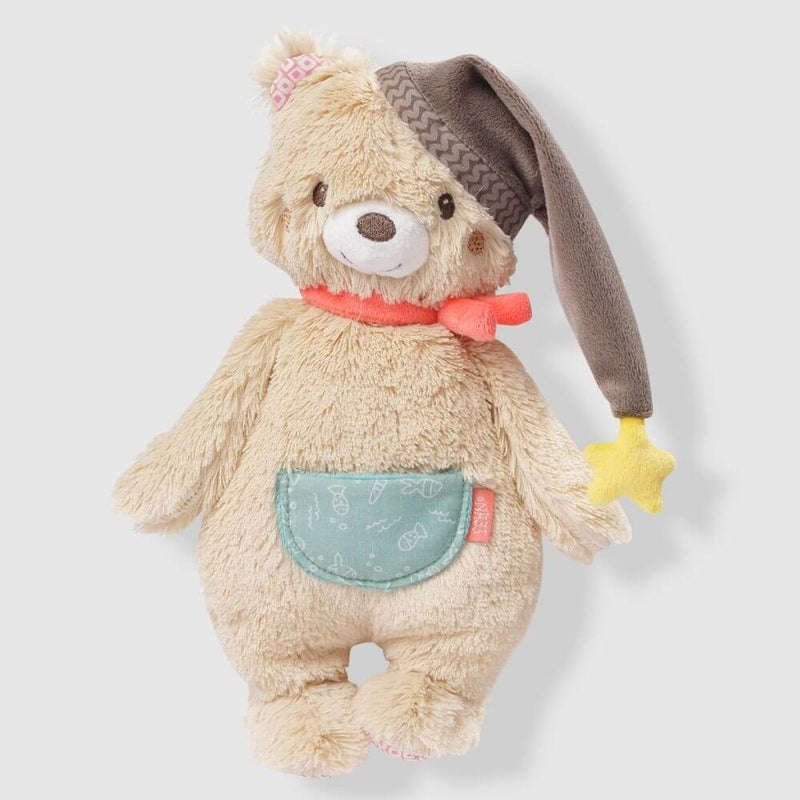Plush teddy bear with a hat and pocket on a light gray background